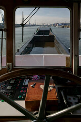 View from ship wheelhouse showing control panel and barge through forward window © Victor