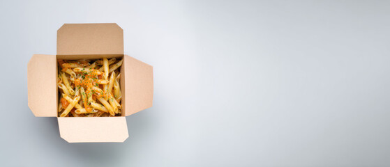 Penne pasta in takeout box on light background
