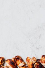 Golden fried chicken pieces on marble background with copy space