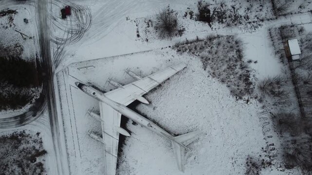 Aerial view of Soviet Tu-95 bomber in snowy landscape. Perfect for historical, military, cold war, and winter aviation projects.
