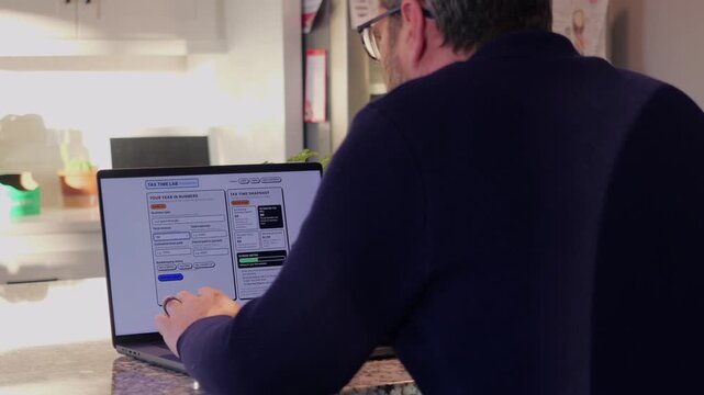 Middle Aged Man Runs Tax Assessment for Home Based Small Business Preparing for Tax Season and Prepayments Concept