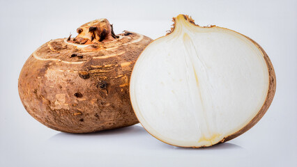 Fresh jicama, large round brown root with crisp white interior, isolated on clean white background.