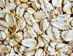 Close up oatmeal flakes surface showing natural organic cereal grain texture