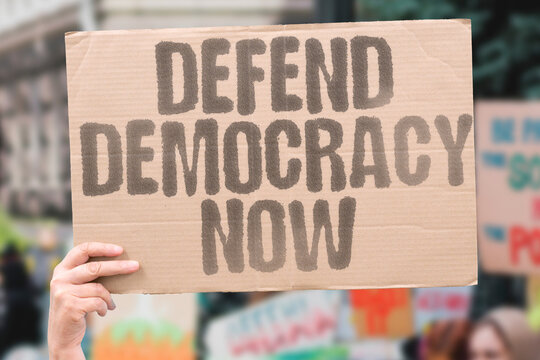 "Defend Democracy Now" Protect democratic systems immediately. PROTECT. DEMOCRATIC. SYSTEMS. IMMEDIATELY. DEFEND.