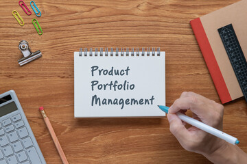 There is notebook with the word Product Portfolio Management. It is as an eye-catching image.