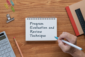 There is notebook with the word Program Evaluation and Review Technique. It is as an eye-catching image.