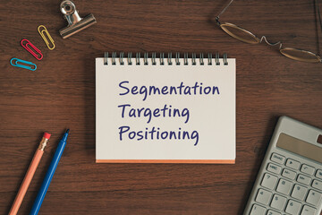 There is notebook with the word Segmentation Targeting Positioning. It is as an eye-catching image.