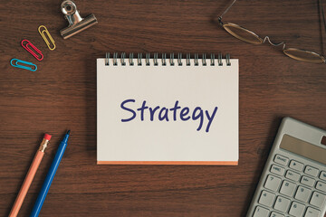 There is notebook with the word Strategy. It is as an eye-catching image.