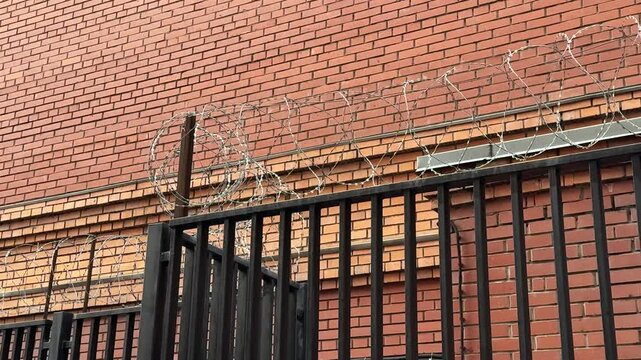Metal Railing Atop Brick Wall CloseUp Tight Composition Highlighting Parallel Bars And Mortar Lines Subtle Weathering Horizontal Rhythm Muted Color Palette Architectural Detail