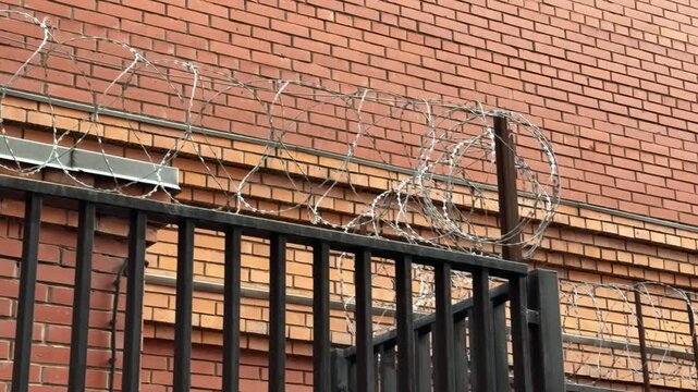 Metal Railing Atop Brick Wall CloseUp Tight Composition Highlighting Parallel Bars And Mortar Lines Subtle Weathering Horizontal Rhythm Muted Color Palette Architectural Detail