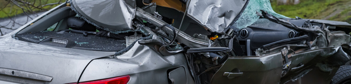 Cars that have been damaged, broken glass, roof collapsed from being crushed