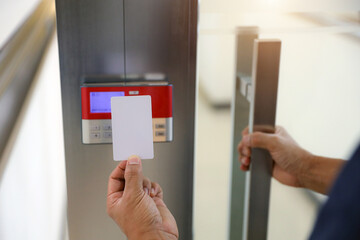 Hand scanning proximity ID card on reader access control system to security door unlock with identity or verification identify icons for safety detect fingerprint scan or check attendance.