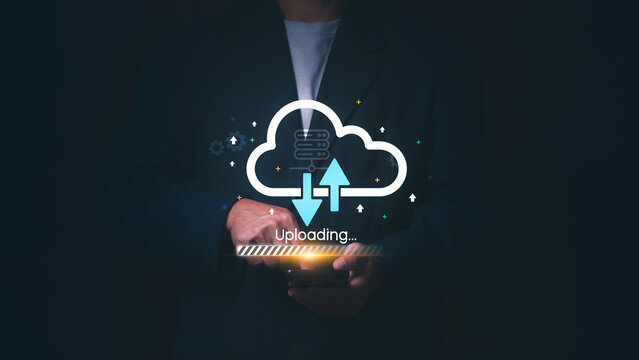 Businessman using a smartphone for cloud computing data transfer with uploading icons, Concept of digital storage, networking technology, big data backup, and global server synchronization. - Powered by Adobe