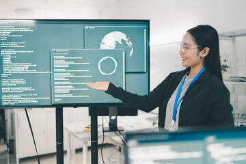 Woman presenting a coding project and analyzing source code at office. The confident woman, bright smiles and focused expressions
