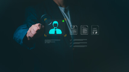 Businessman using magnifying glass to screen candidate profile and digital resume, Concept for human resources management, recruitment process, talent acquisition, and professional hiring evaluation.