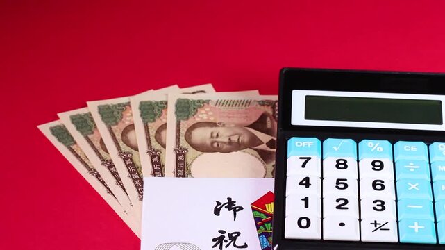 1万円札と祝儀袋と計算機　回転