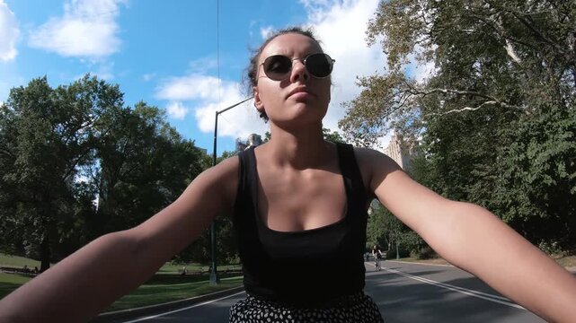 Young female tourist enjoying the bike ride in Cental Park, New York in midtown Manhattan. Central Park is on of the main attraction for tourists in New York