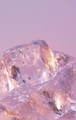 Ice cubes melting on light purple background