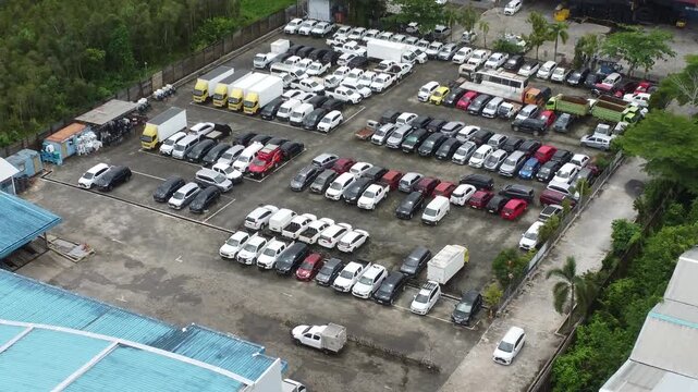 Aerial view of a parking lot lined up with cars for rent