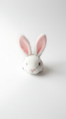Minimalist Easter Bunny Ears Peeking from Torn Paper Hole on Clean White Background with Copy Space, Simple Spring Holiday Concept