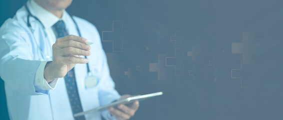 Doctor holding digital tablet and pointing stylus pen at virtual screen. Medical healthcare concept with abstract blue cross pattern background and copy space.