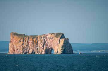 Famous limestone sea rock with a natural arch rising from the ocean near Perce in Gaspesie, Quebec, Canada. Iconic coastal landscape and travel destination.