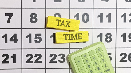 Calendar marking tax time with a calculator symbolizes financial planning and accounting for fiscal responsibilities