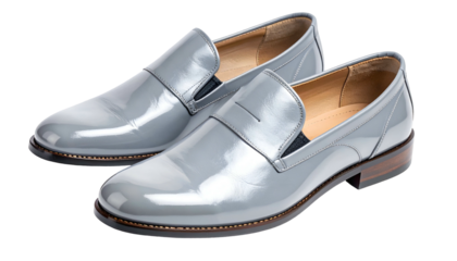 A pair of sleek, shiny gray leather loafers, presented on a transparent background for product display