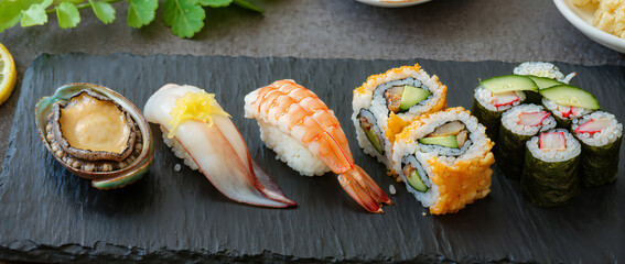 Fresh and Colorful Sushi Selection on Slate Plate with Garnish and Side Dishes