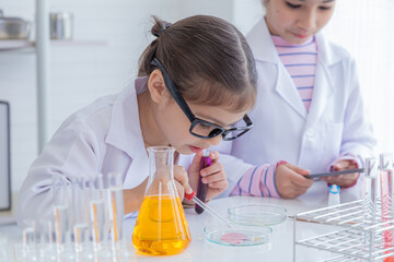 Group of sibling students kids lab coat uniform studying science class in laboratory, Iranian pupils girls scientists having fun at school in lab with microscope and test tube, kid scientist concept