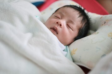 newborn baby sleeping on the bed 