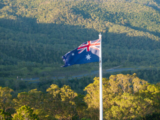 Scenic elevated views of the Australia flag on display at the Picnic Point public park area in Toowoomba with Table Top Mountain and the Bushland Reserve in the background, Queensland, Australia