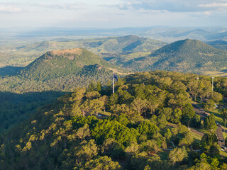 Scenic elevated views of the Australia flag on display at the Picnic Point public park area in Toowoomba with Table Top Mountain and the Bushland Reserve in the background, Queensland, Australia