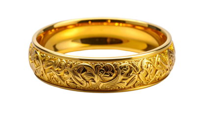 Close-up of a decorative, gold-colored ring, exhibiting ornate floral scrollwork around the band. The ring is isolated on a black background