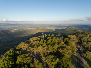 Scenic elevated views of the Australia flag on display at the Picnic Point public park area in Toowoomba with Table Top Mountain and the Bushland Reserve in the background, Queensland, Australia