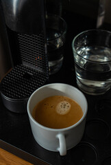 Coffee machine and americano drink in the mug