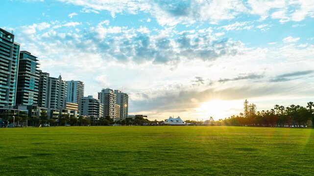 Sunrise timelapse at Langley Park, Perth, Western Australia. Early morning light illuminating the sky and city skyline, peaceful urban park landscape, time lapse nature and city scenery.