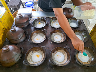 The process of making serabi. Serabi is made from a mixture of flour, coconut milk, and palm sugar, baked in small earthenware pans. It's delicious as a snack or breakfast.
