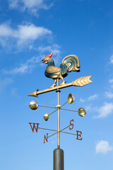 Retro weather vane and sky