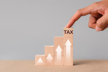 The concept of tax filing season, wooden blocks and tax symbols on tax blocks for financial...