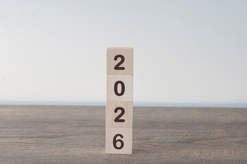 The wooden cube representing the year 2026, a symbol of the new year.