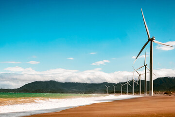 Aerial view of Bangui Wind Farm windmills along the coast of Ilocos Norte, Philippines at sunset.