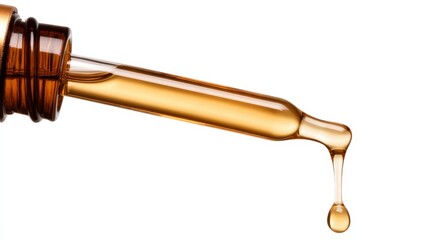 A close-up of a dropper releasing a golden liquid, highlighting its texture and color against a white background.
