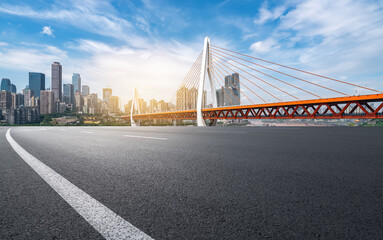 Naklejka premium Urban Road with Suspension Bridge and Skyscrapers