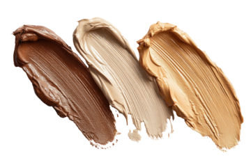 Three foundation swatches in varying skin tones on black