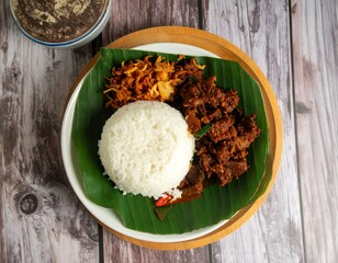Delicious traditional meal served on banana leaf with rice and meat