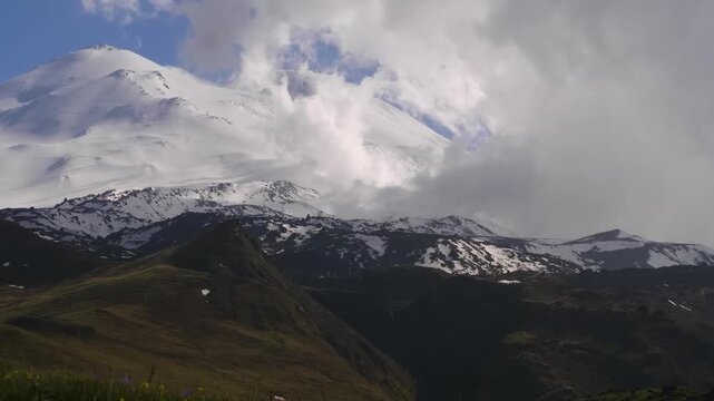 panoramic view of the majestic, snow-covered, two-peaked dormant volcano, Mount Elbrus, the highest peak in Europe, as seen from Mount Cheget in the Kabardino-Balkaria Republic, Russia. The vast mount