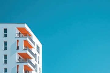 Modern White Apartment Building With Orange Balconies Against Bright Turquoise Sky