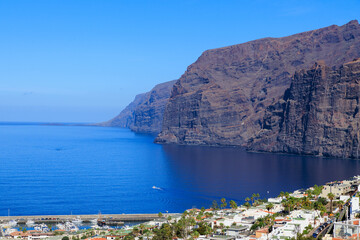 Panorama with vertical cliffs of the Giants (Acantilados de Los Gigantes), townscape of Los Gigantes and Atlantic Ocean at Canary Island Tenerife, Spain
