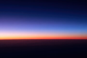 Dramatic Sky Gradient Over Clouds at Twilight with Blue Purple and Orange Hues